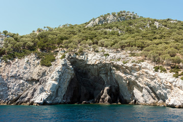 Fototapeta na wymiar Rocky coast and gorgeous waters in Kelyfos islet, Marmaras, Chalkidiki, Greece