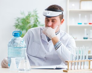 Young chemist student experimenting in lab