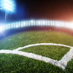 A football field corner and lights with flashes at night