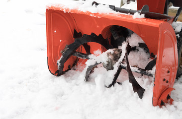 closeup of the first stage impeller of an orange snow blower