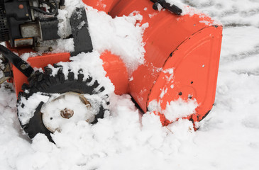 closeup of the side of an orange snow blower