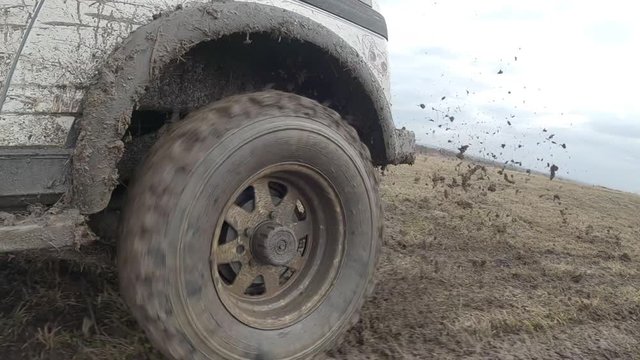 4x4 offroad car spin wheel in the water and mud slow motion