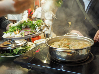 Traditional vietnamese hot pot with fish and seafood. Street food.