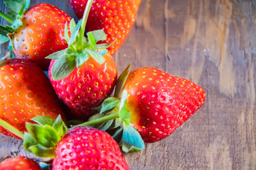 strawberry berries close up on a wood background