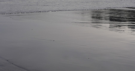 Seawater textures and reflections on a cold winter day at the beach