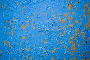 Blue iron old scratched ragged sheet metal wall with spots of dirt and drops of earth. Texture, background