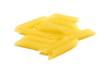Various uncooked pasta on a wooden background. Cannelloni, pipe, penne,fusilli pasta.