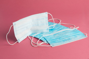 a pile of surgical masks sometimes used for protection from airborne viruses like corona virus