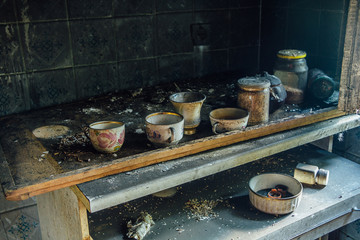 Burnt room interior. Burnt still life. Charred wall, cups in black soot