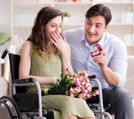 Man making marriage proposal to disabled woman on wheelchair
