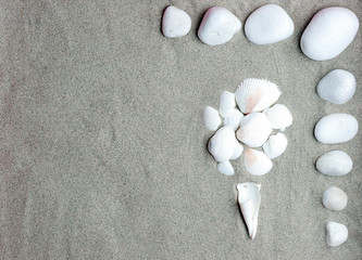set of conch shells (ice cream shape, summer), and white stones on beach sand