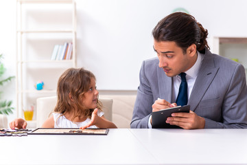Child psychologist attending small girl