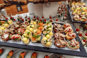 Different snacks on wooden tray near the bar