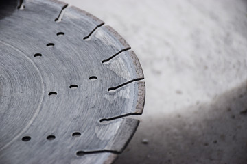 Concrete cutter machinery and cutting blade on a driveway