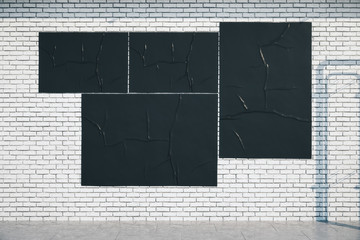 Blank three black billboards on loft style brick wall.