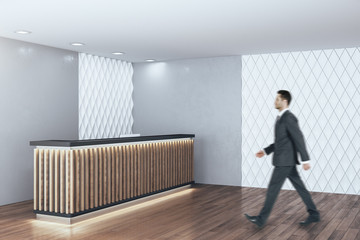 Businessman walking in modern hotel hall