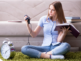 Female student being distracted from exam preparation