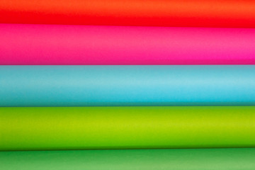 Picture of colored scrolls arranged in green, red, blue, and pink