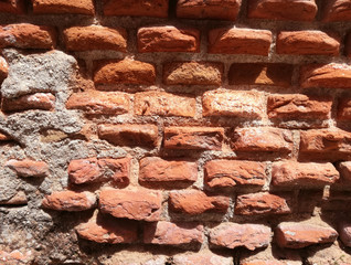 Fototapeta premium Reddish construction, texture. Ancient and genuine wall. Solid red clay brick very old.