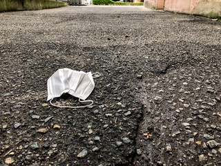 Protective face mask improperly disposed of in Kobe, Japan.
