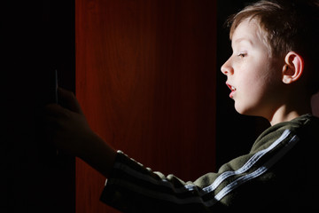child open door and bright lit illuminate him