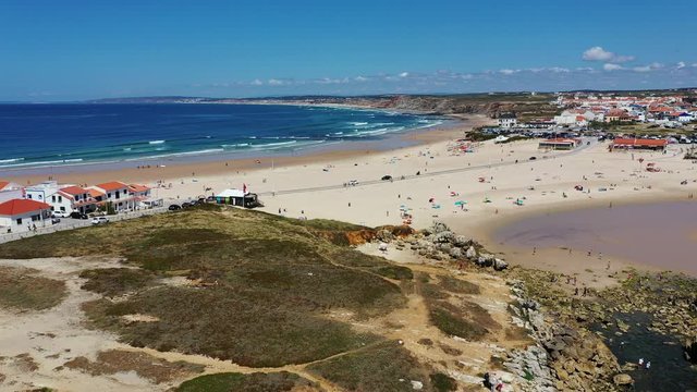 Aerial view of island Baleal naer Peniche on the shore of the ocean in west coast of Portugal. Baleal Portugal with incredible beach and surfers. Aerial footage of Baleal, Portugal. 4k quality