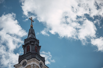 Fototapeta na wymiar Church tower with blue sky in the background