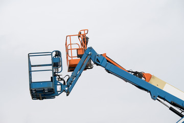 Colorful cherry picker crane buckets in the air