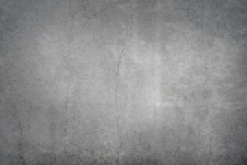 Texture of a smooth gray concrete wall with cracks as a background or wallpaper