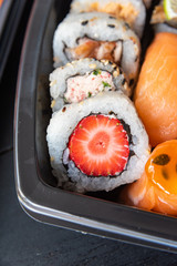 Various sushi on the plate on the table - detail