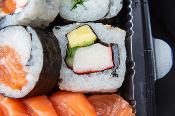 Various sushi on the plate on the table - detail