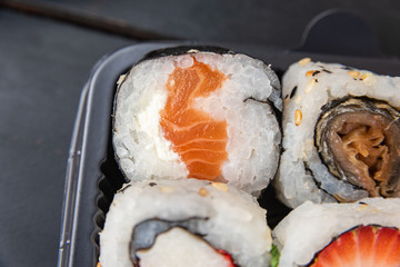 Various sushi on the plate on the table - detail