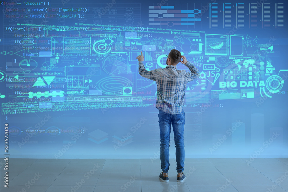Poster male programmer using virtual screen, back view