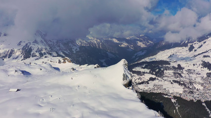 Fototapeta na wymiar Flight over a snowy mountains in winter - wonderful Swiss Alps - aerial photography