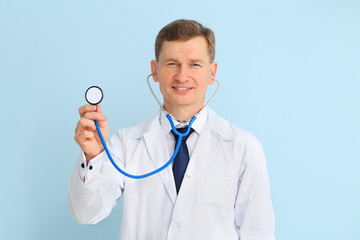 Male cardiologist on color background