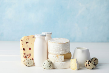 Different dairy products on white table