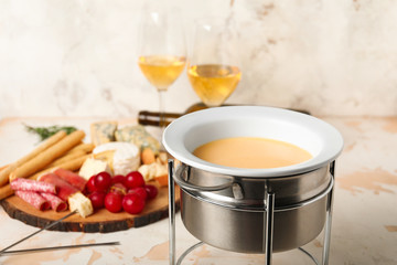 Cheese fondue with snacks on white background