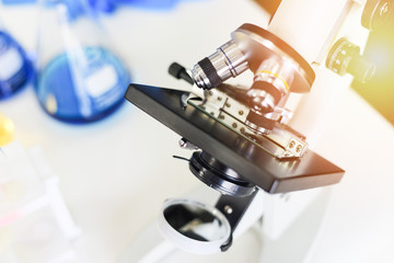 Microscope in modern lab for scientist research or medical - microscope with metal lens at laboratory biochemistry genetics forensics microbiology test tube
