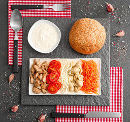Ingredients for tasty doner kebab and sauce on dark background on dark background