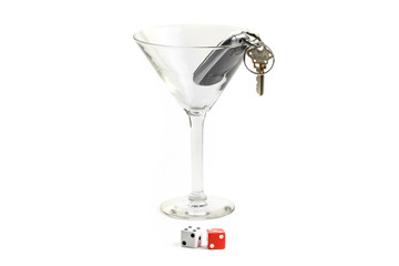 driving safety; car keys in a martini glass with a pair of dice lucky seven; do not gamble isolated on white