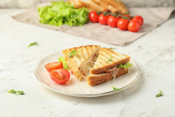 Plate with tasty sandwiches with cheese on white background