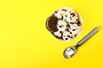 Bowl with tasty ice cream on color background