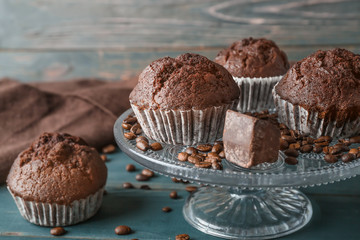 Dessert stand with tasty chocolate muffins on table