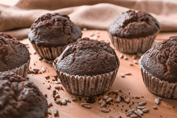Tasty chocolate muffins on table