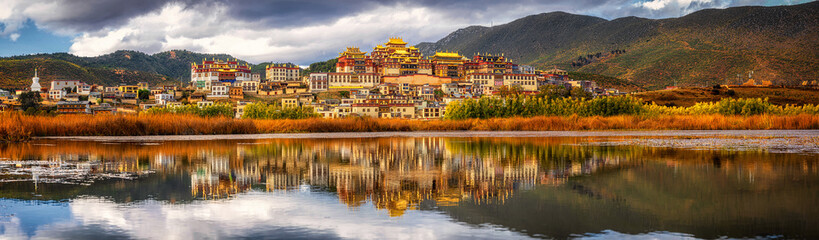 Panorama scene of Songzanlin Temple, is Tibetan Buddhist monastery in Zhongdian city, Shangri-La, Yunnan province, China, travel and tourists,famous place and landmark,religious and holiday concept - obrazy, fototapety, plakaty