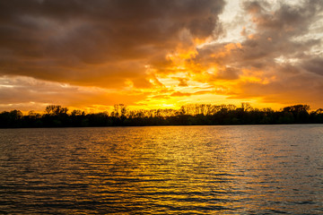 Fototapeta na wymiar Beautiful landscape with maschsee lake and golden sunset in April an artificial lake situated south of the city centre of Hanover in Germany