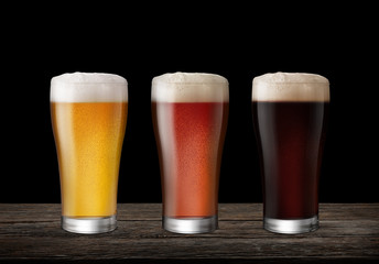 Three Glasses of Light Beer and Dark Beer isolate black background with copy space