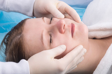 Fototapeta na wymiar facial massage for a girl in a spa salon, beauty and care