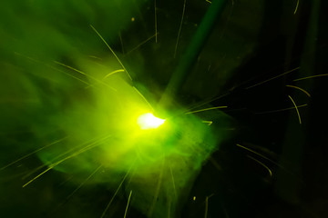 Metal pipe during welding. Sparks and scale