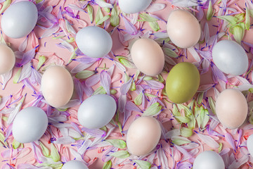 Easter eggs on a spring background, pink with flower petals, soft tones, yellow, white, warm, blue and purple colors